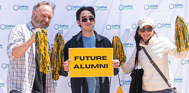 A family hold a Future Alumni sign